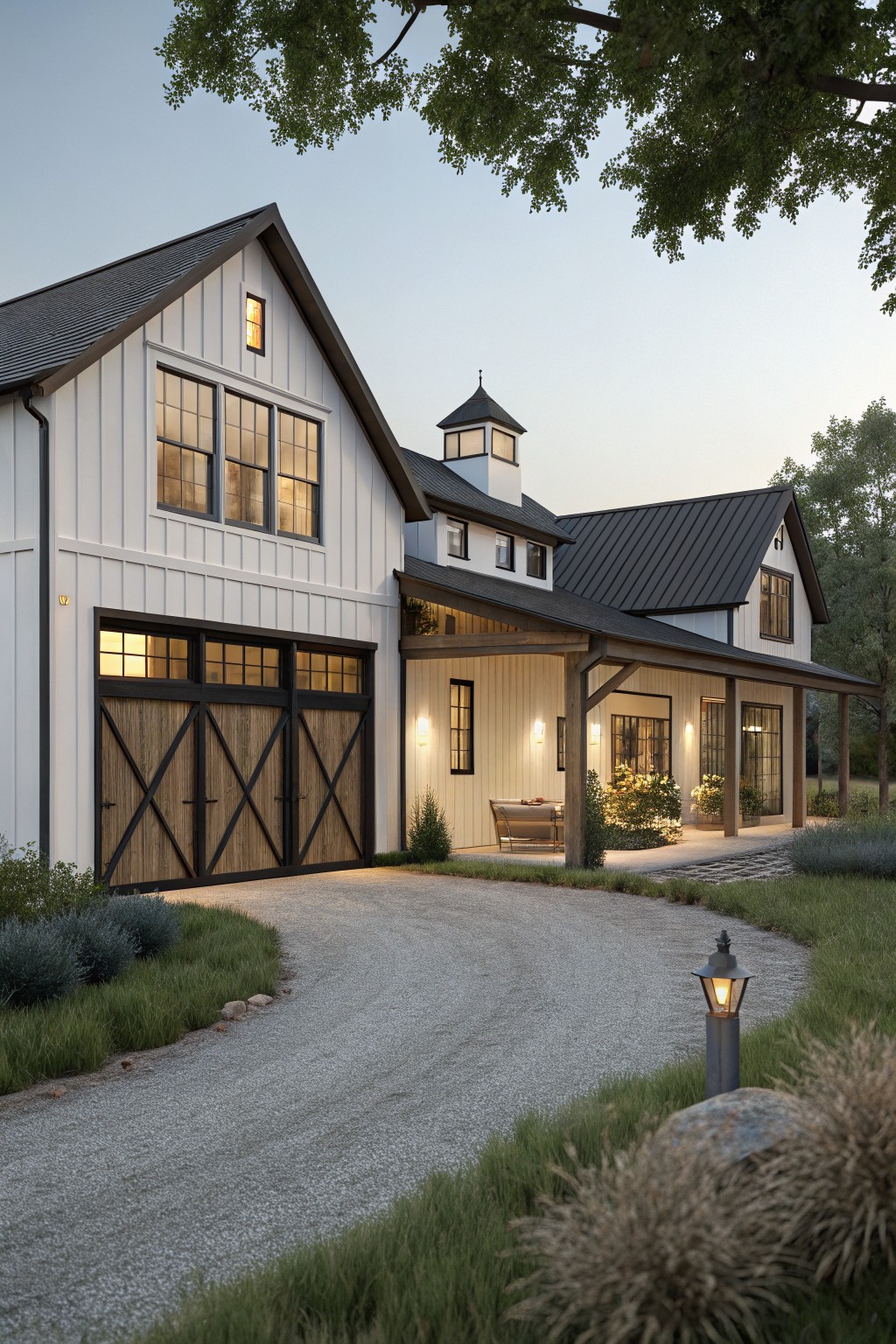 Modern farmhouse exterior with white board-and-batten siding, attached side garage with black-trimmed wooden barn doors, covered porch breezeway, gravel driveway, and surrounding low shrubs and grasses at dusk.