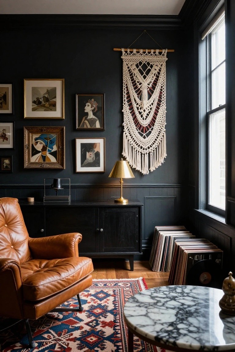 Corner of a dark navy living room with tan leather armchair, black credenza, brass lamp, macrame wall hanging, framed artwork, stacked vinyl records, marble side table, and patterned rug on wood floor.