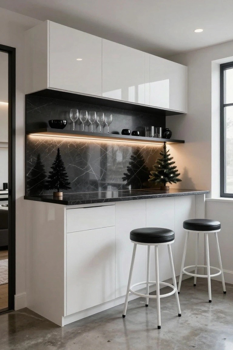 Modern kitchen bar with white glossy cabinets, black veined marble countertop and backsplash holding small black Christmas trees, two black leather stools on white metal legs, and LED lighting under upper cabinets.
