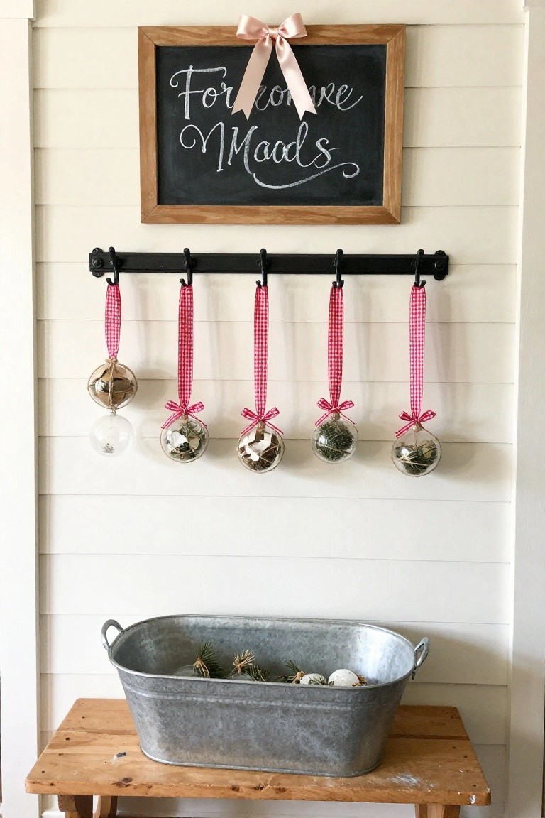 Chalkboard with pink bow above hanging ornaments on black rack.