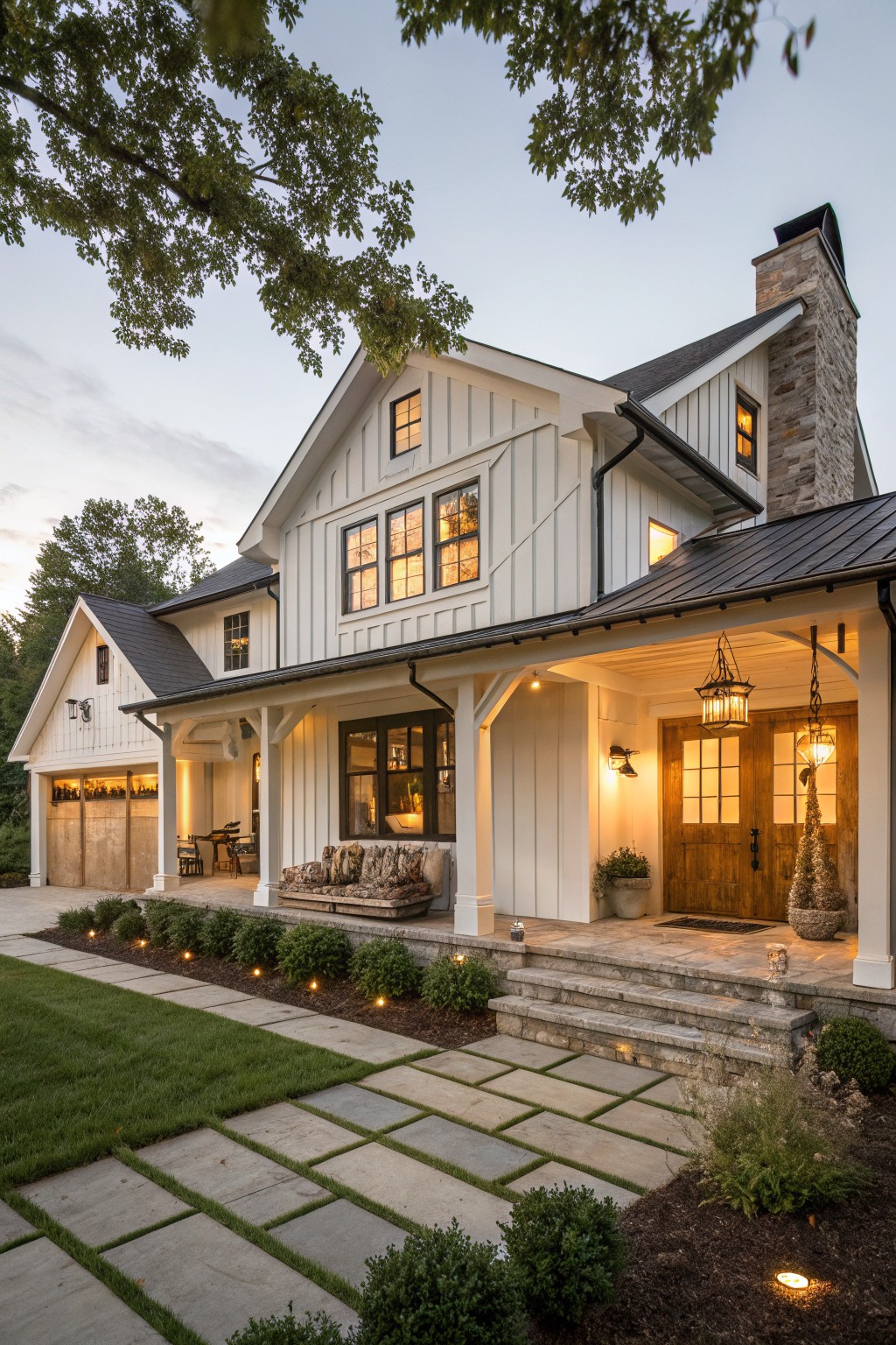 A white two-story farmhouse with wooden front doors, wood trim details, a stone chimney, and a stone pathway leading to the covered porch.