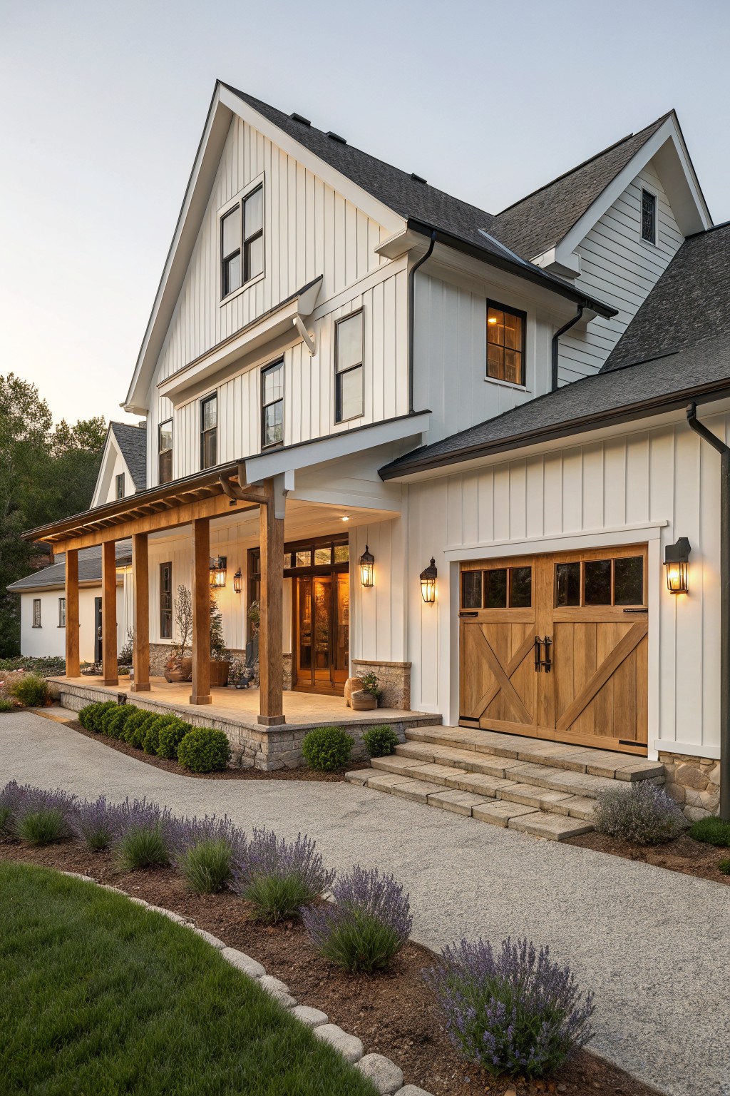 White modern farmhouse with wooden porch, barn doors, stone steps and lavender landscaping