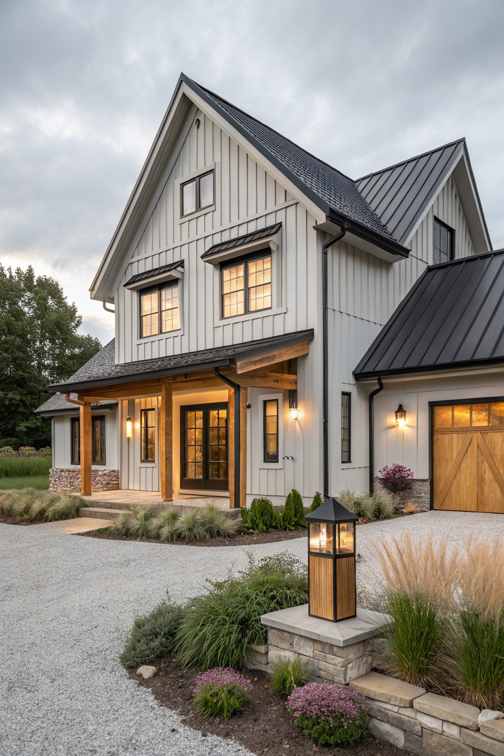 A two-story farmhouse exterior with white vertical siding, black metal roof, and natural wood posts and beams framing the front entry.
