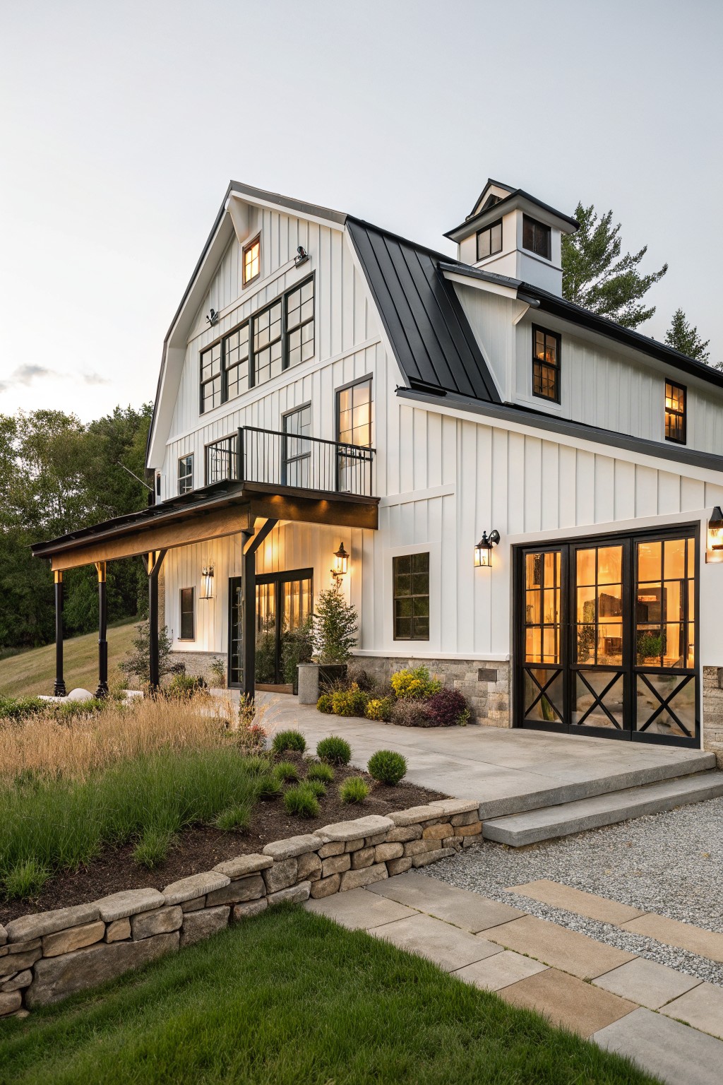 A white two-story farmhouse with black trim, black-framed windows and doors, a black metal roof, and a covered porch on the left side.