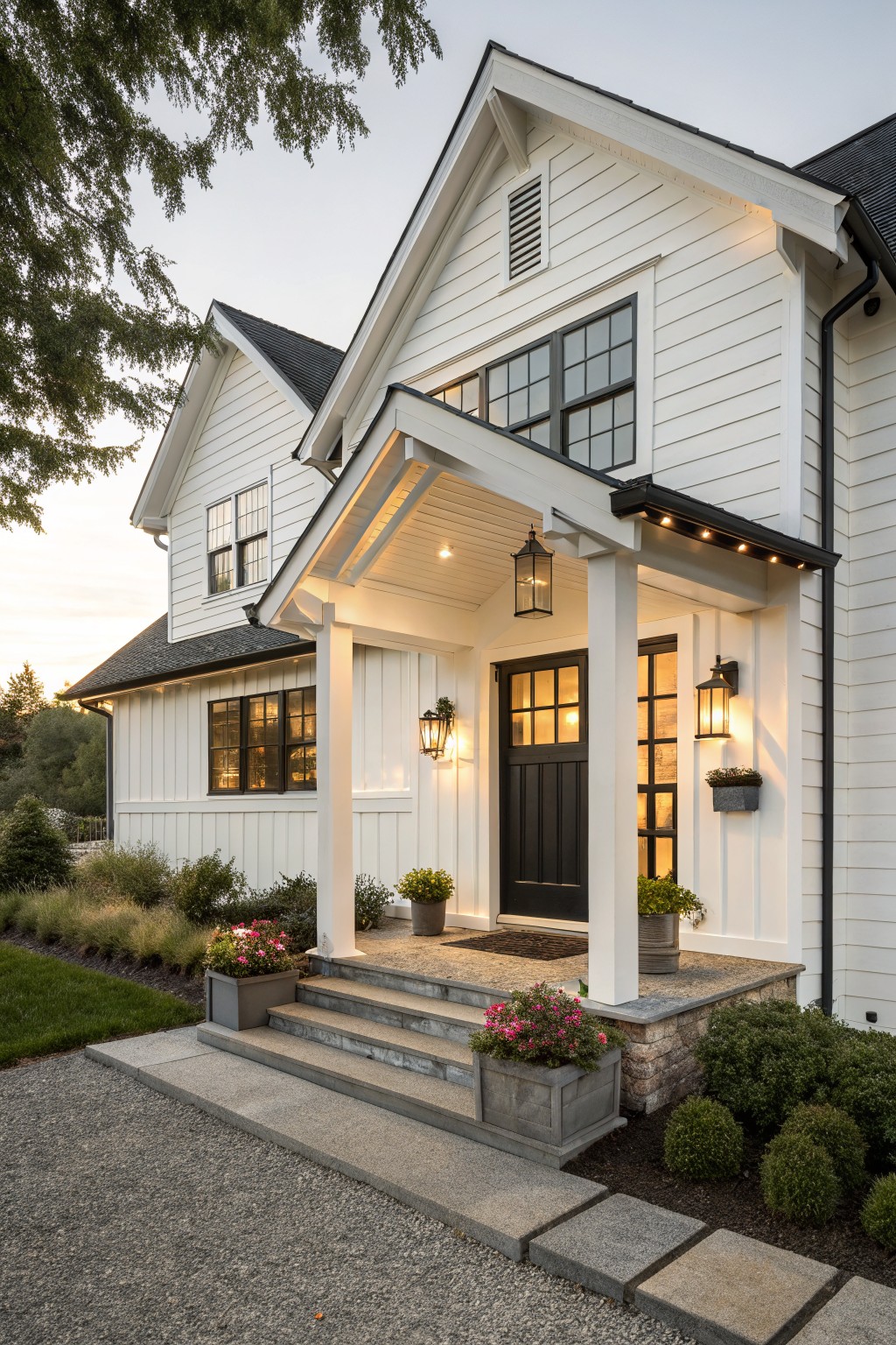 A white modern farmhouse exterior with black front door, black window frames, white columns, and a covered porch entrance.