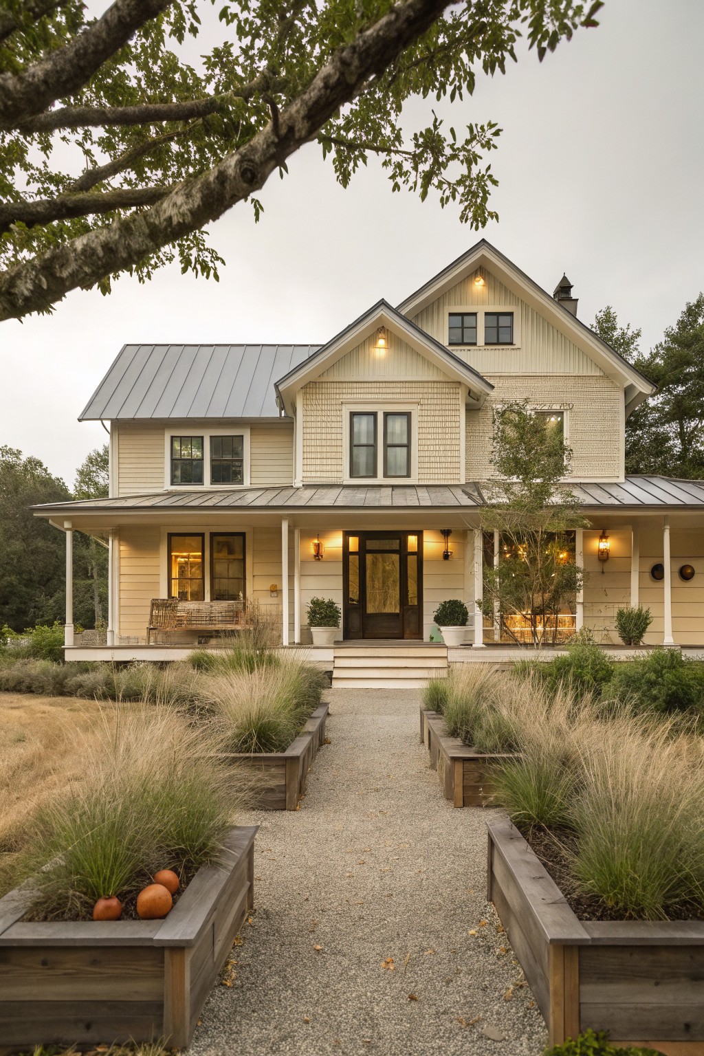 Two-story farmhouse with porch, gravel path, and wooden planters of tall grasses.