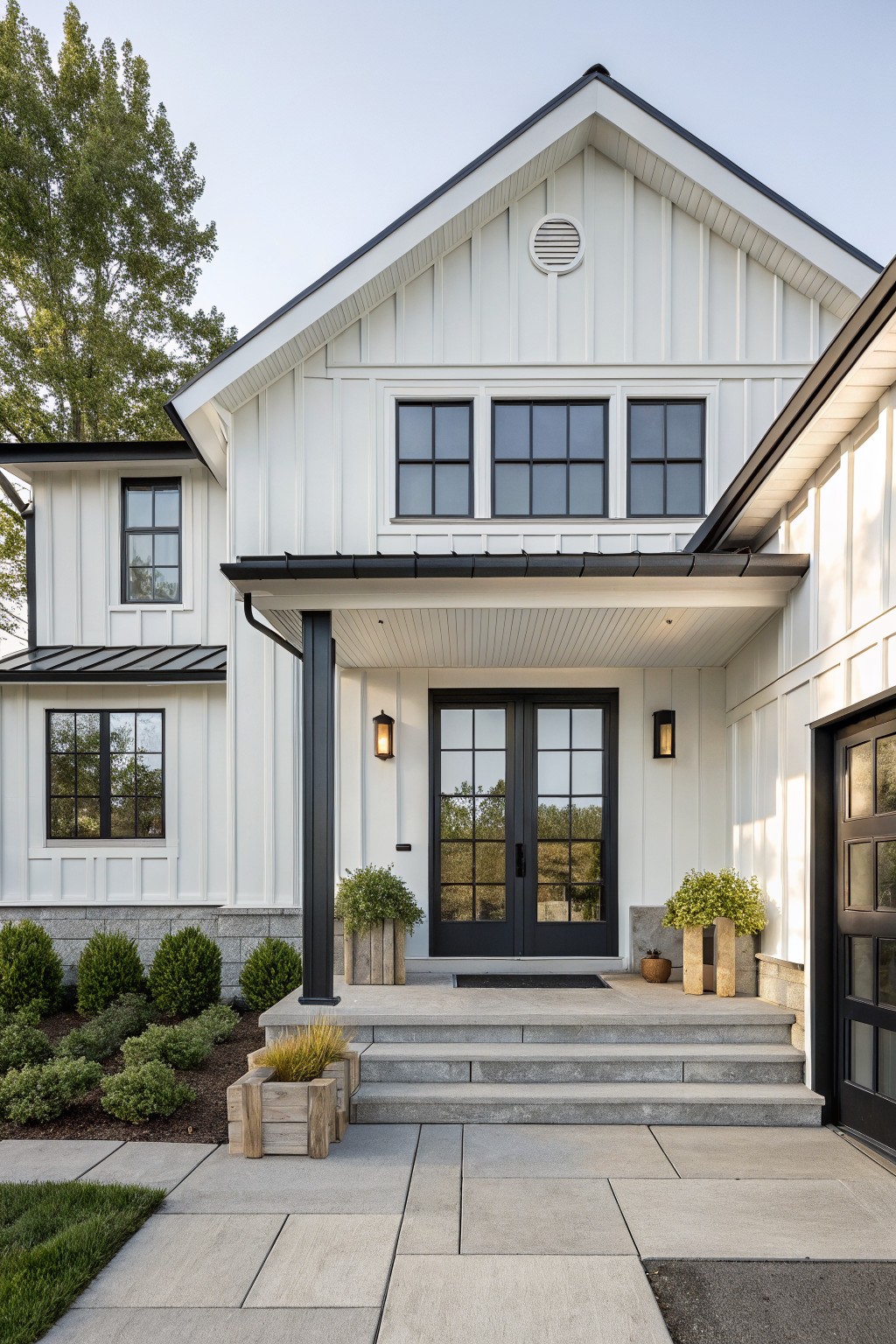 Front view of a white farmhouse with black double entry doors, black window frames, black trim, and a covered porch with concrete steps.