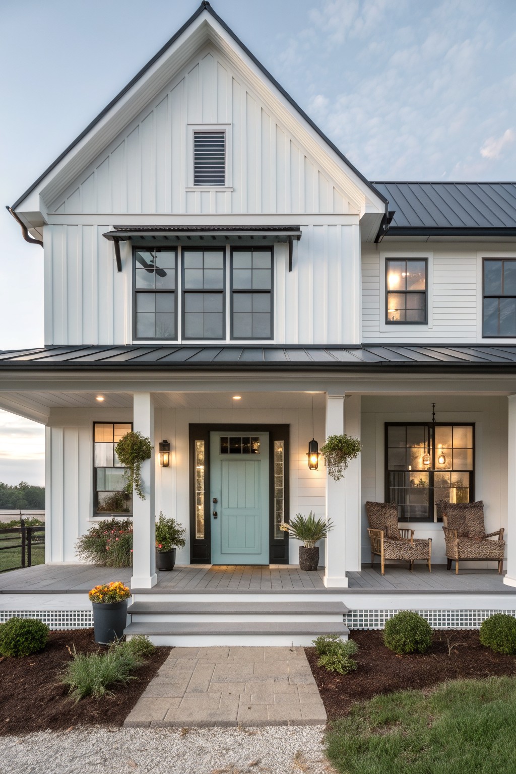 White farmhouse exterior with vertical siding, a light teal front door, black window trim, and a covered front porch.