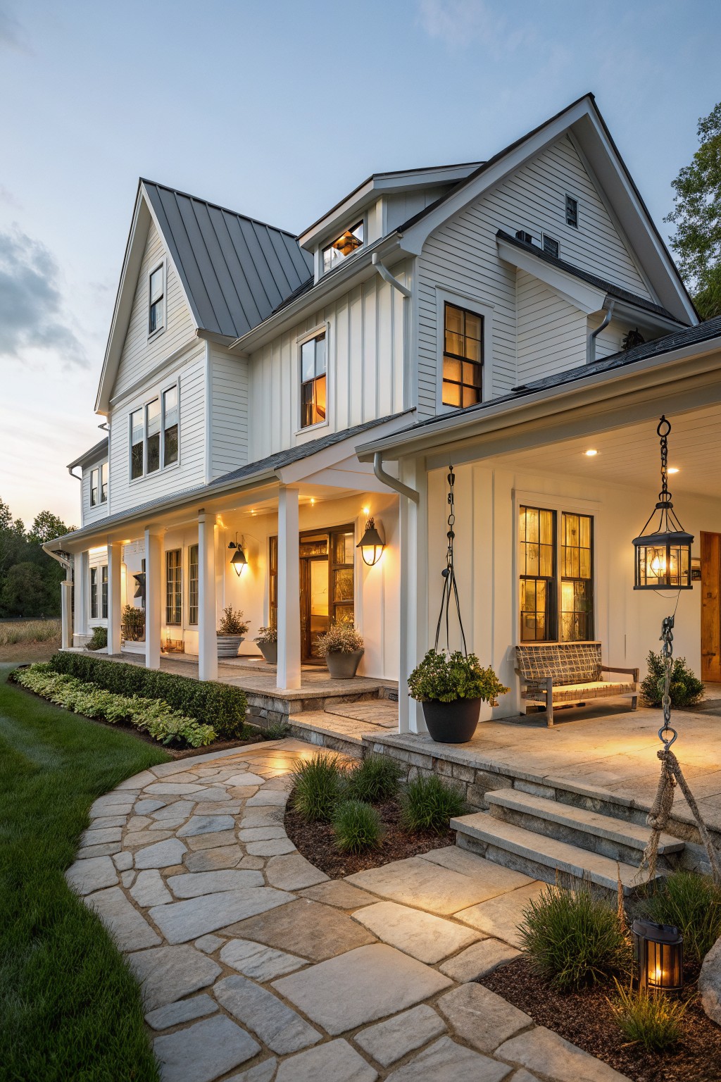 A white two-story farmhouse with board and batten siding, a dark metal roof, a covered porch, and a stone pathway leading to the front steps.