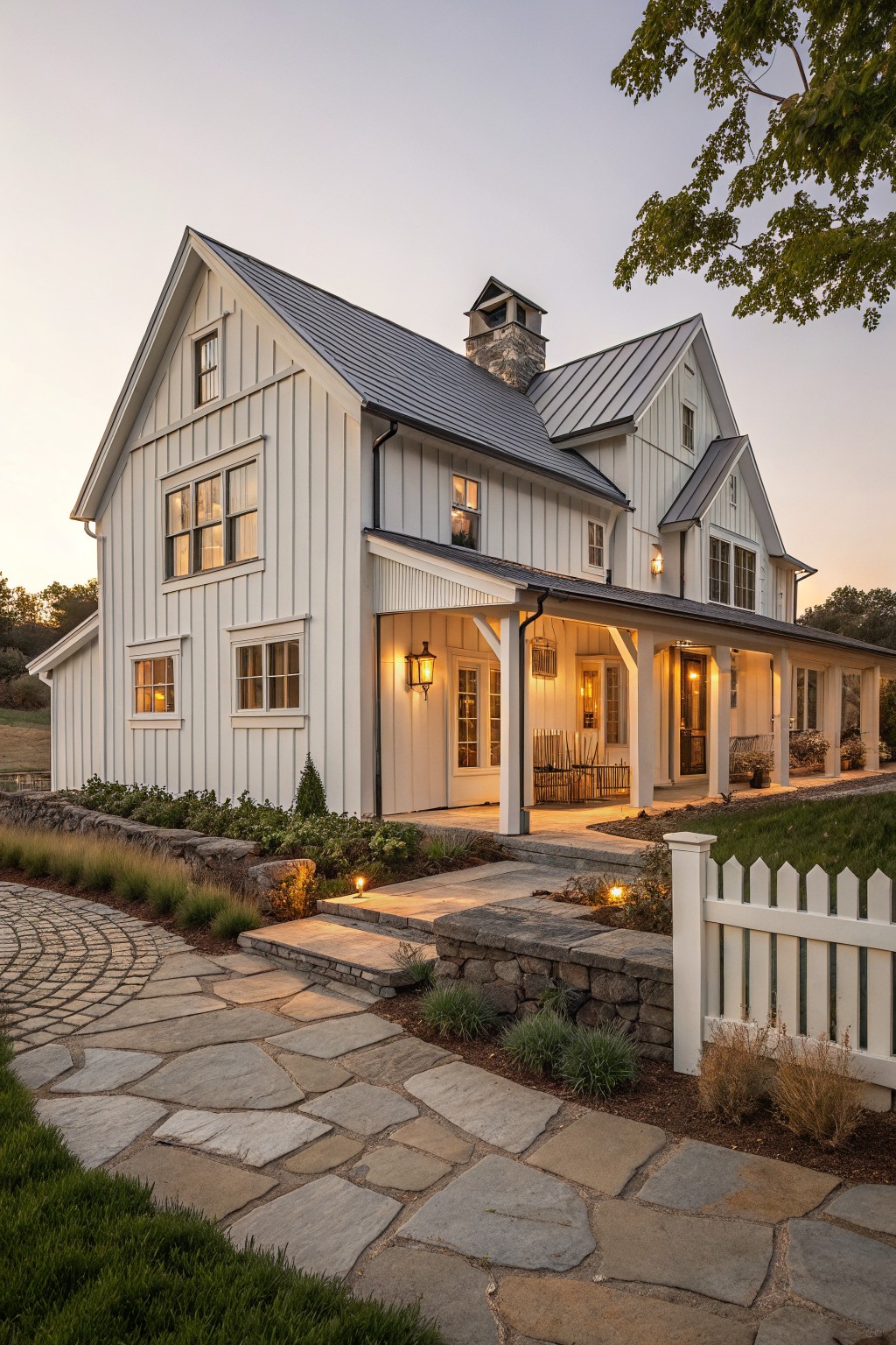 A white board and batten farmhouse exterior with a covered porch, stone steps, and a flagstone path.