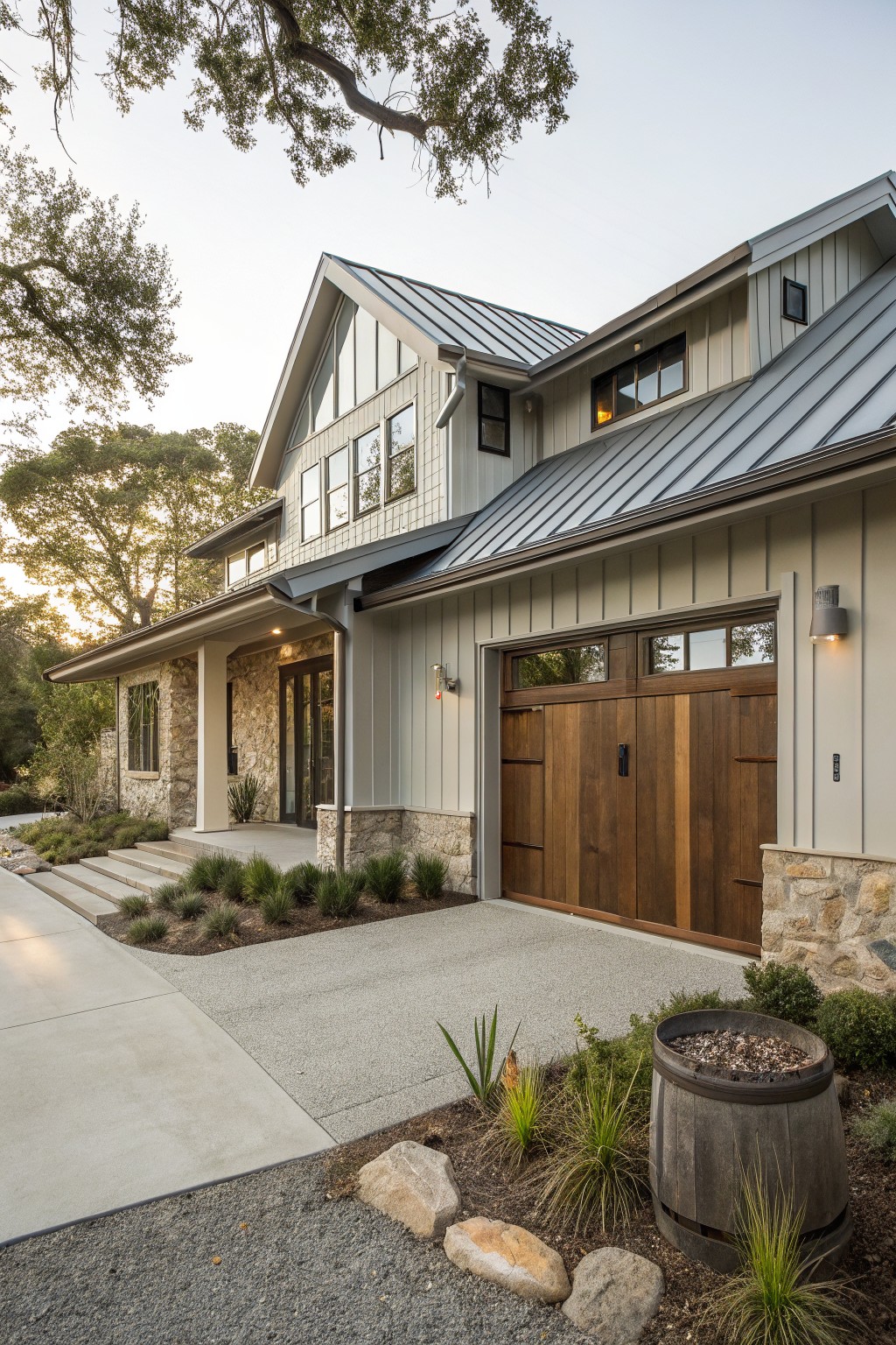 A modern farmhouse exterior with a wooden garage door, stone foundation, light siding, and metal roof.
