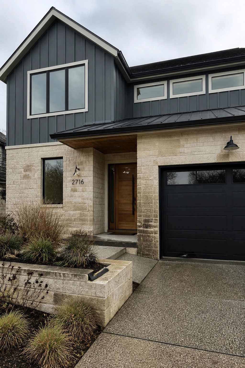 Dark charcoal gray siding on the upper exterior of a stone farmhouse.