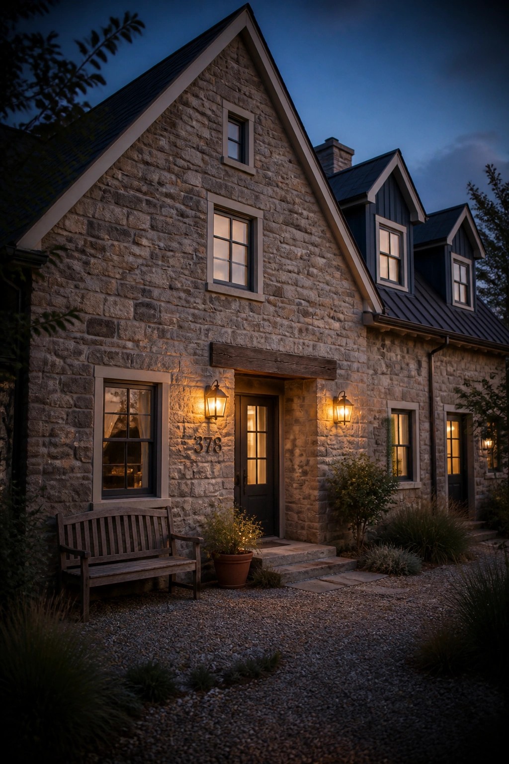 Stone farmhouse with deep navy painted gables and dark trim.