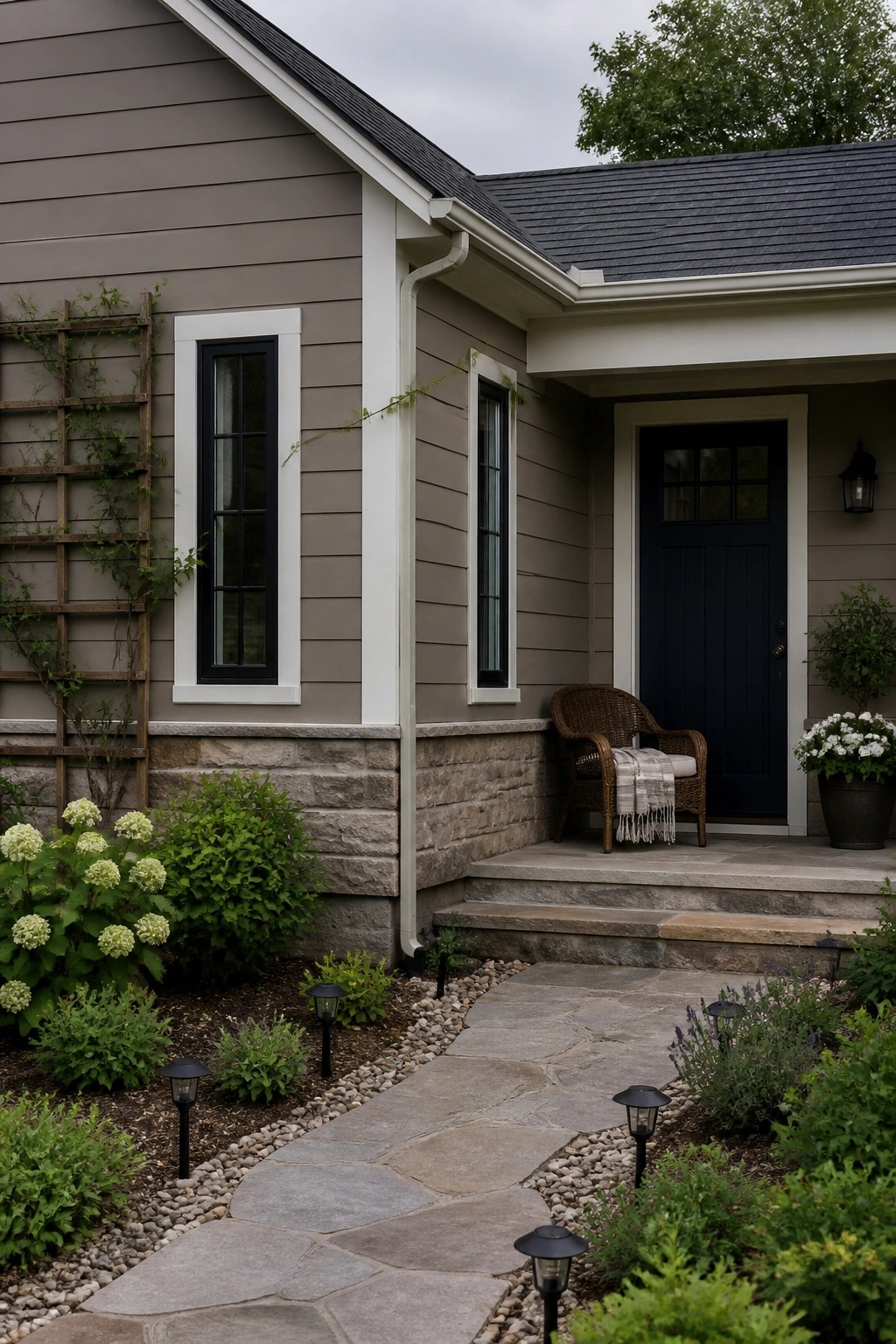 A house with warm greige siding and a stone foundation.