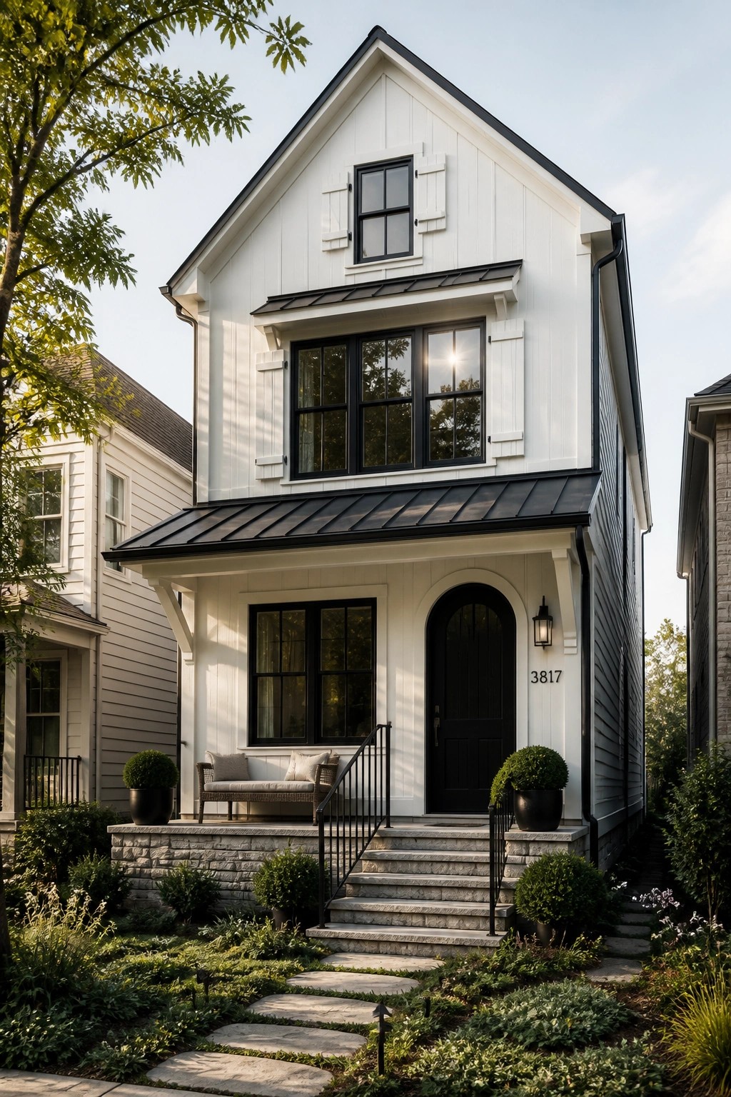 White modern farmhouse siding with black windows and door.