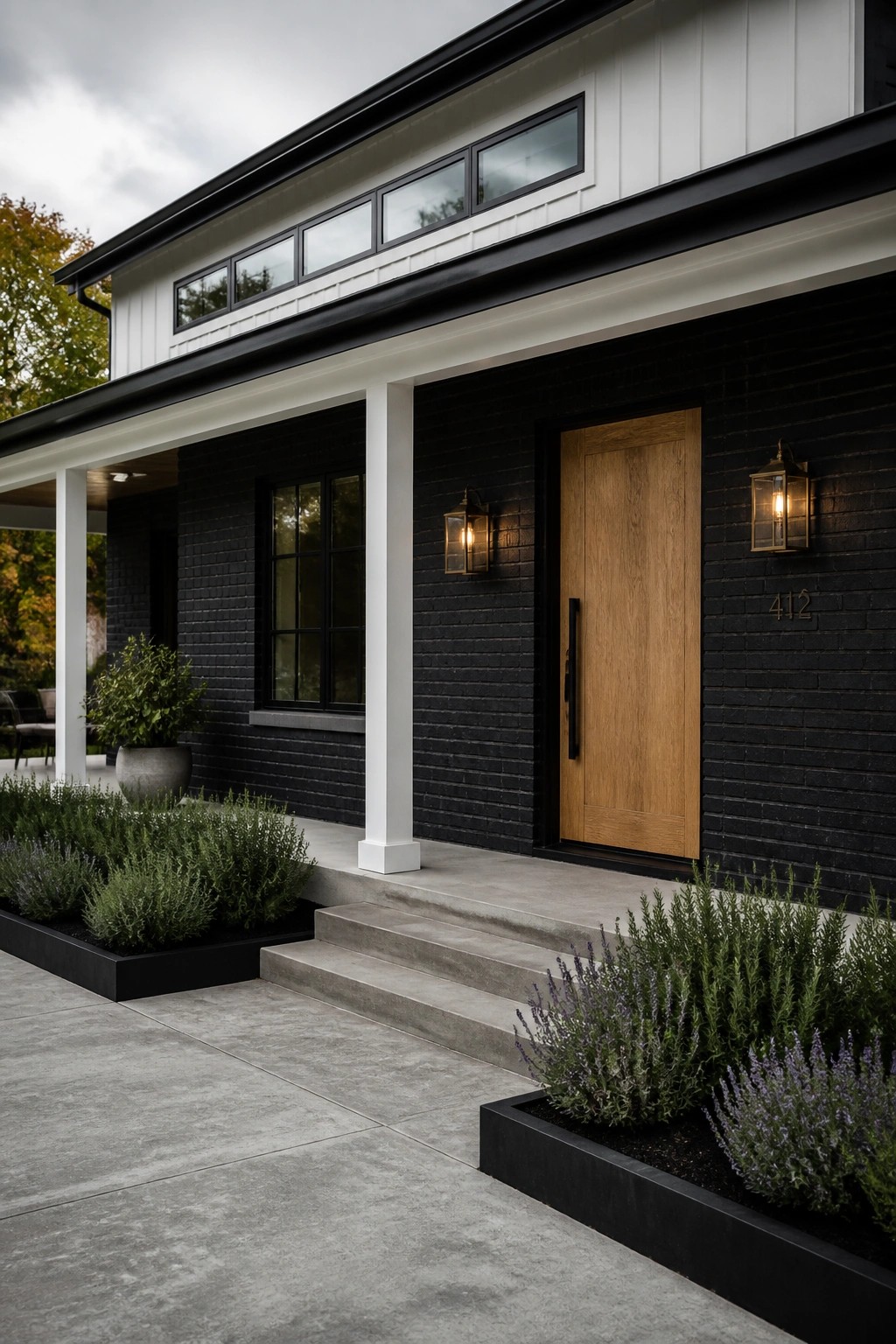 Modern black brick house with wooden door, concrete steps, and lantern lights.