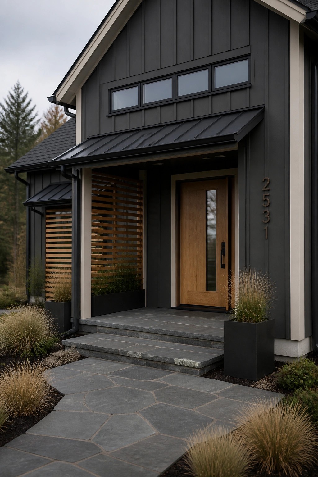 A farmhouse exterior clad in dark charcoal gray siding with a wooden front door.