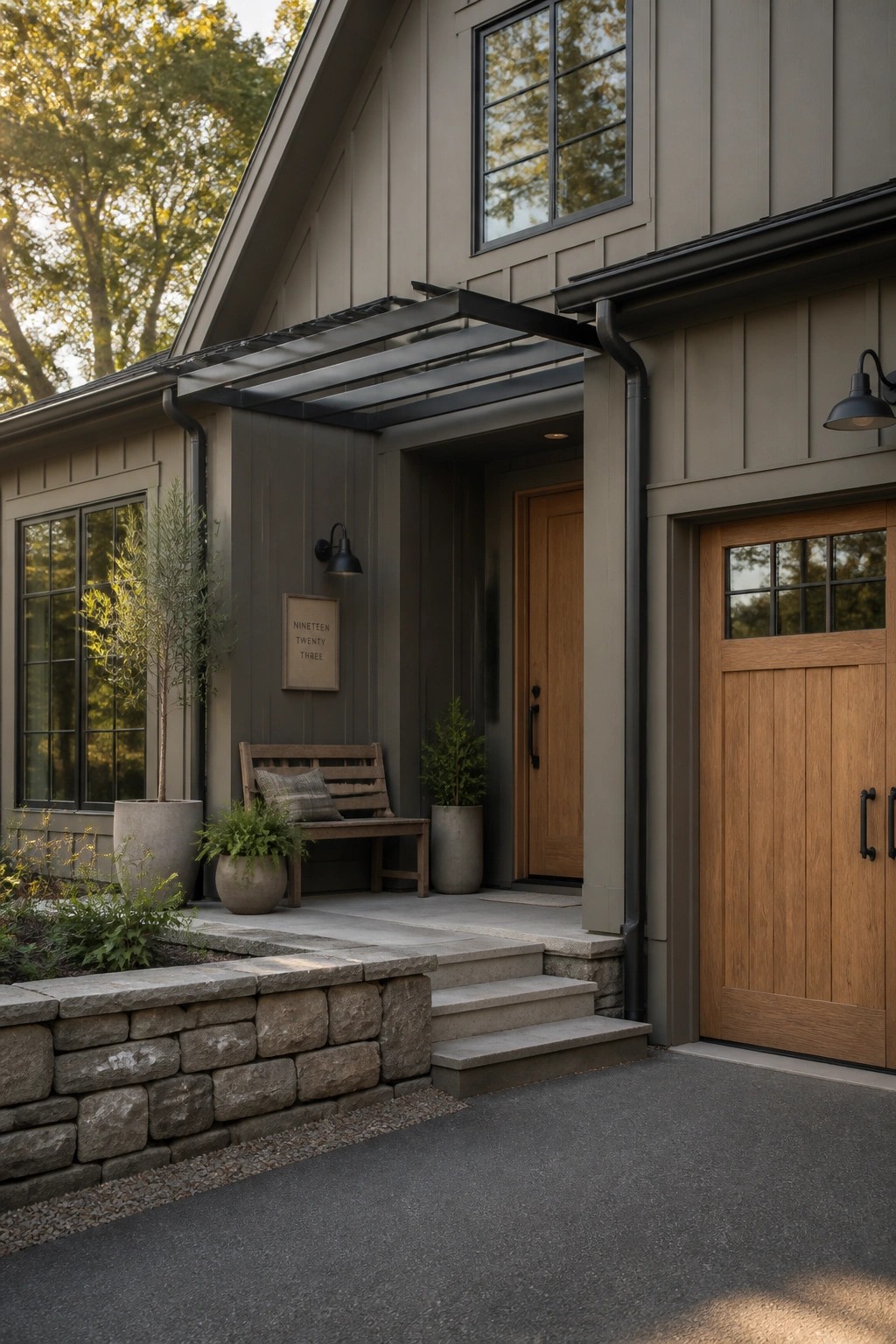A house exterior painted in warm greige siding with wood doors and stone steps.