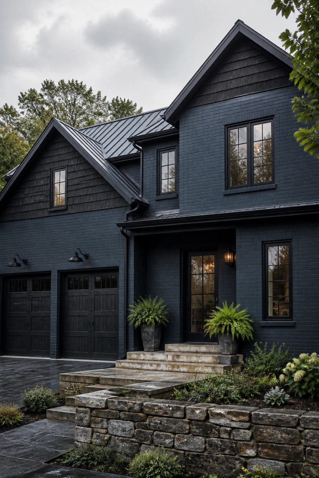 A modern farmhouse exterior finished in dark blue gray paint with black trim.