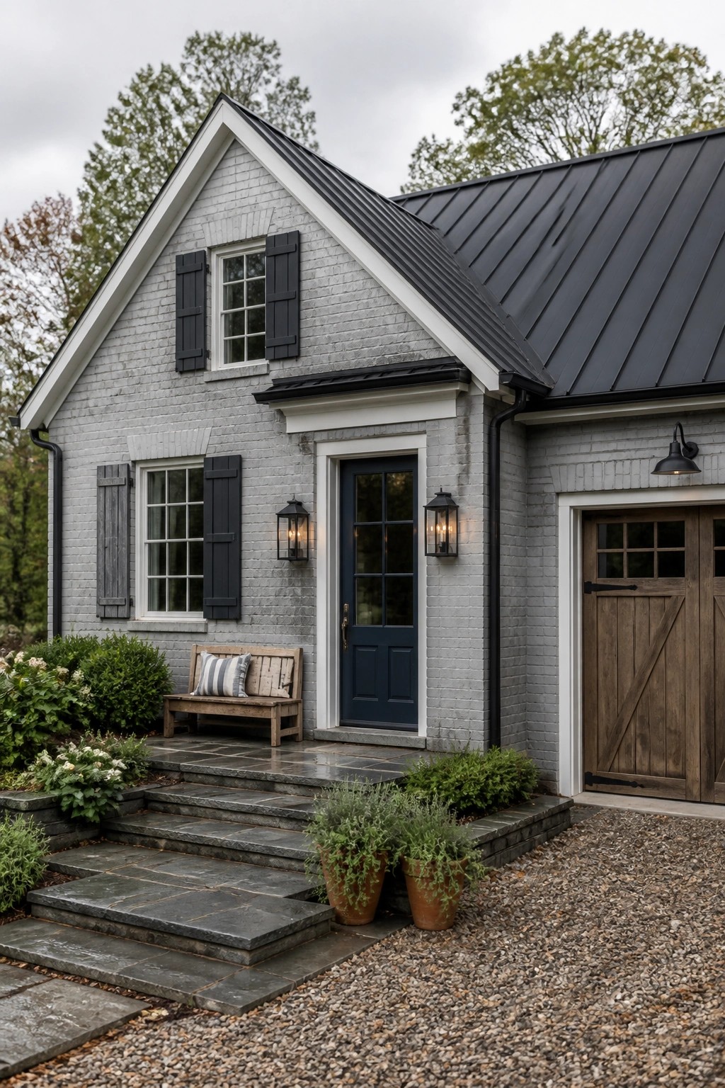 Light gray painted brick on a modern farmhouse exterior with dark roof and stone steps.