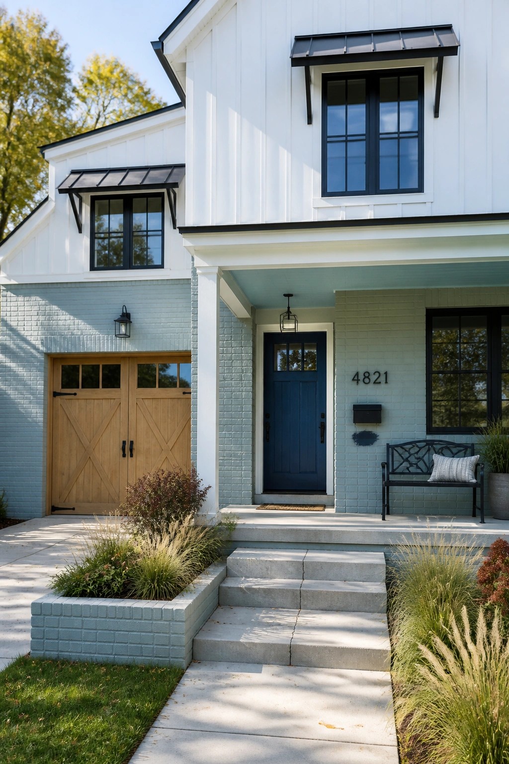 A modern farmhouse exterior with light blue gray painted brick.