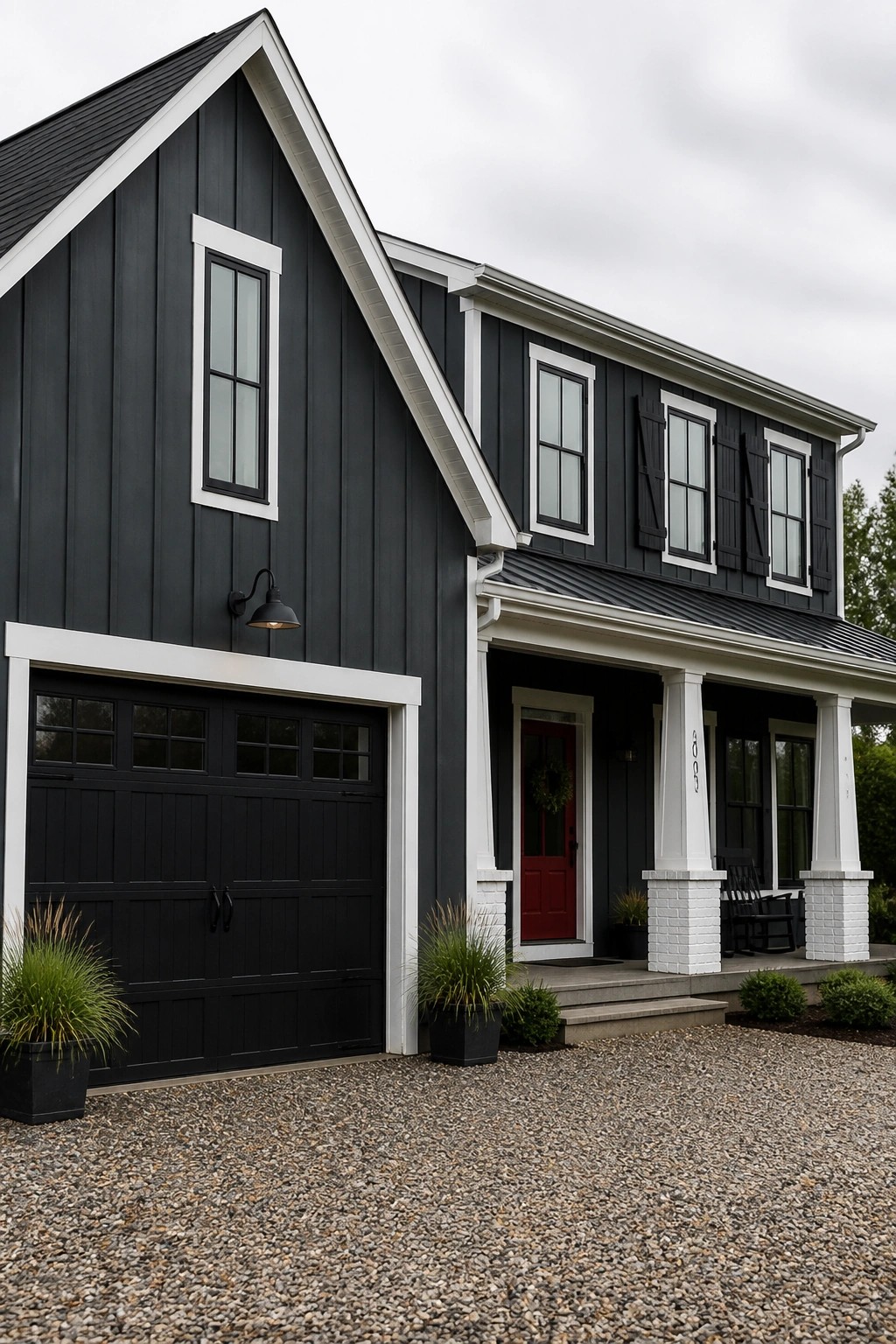 A farmhouse exterior painted in deep charcoal gray with white trim.