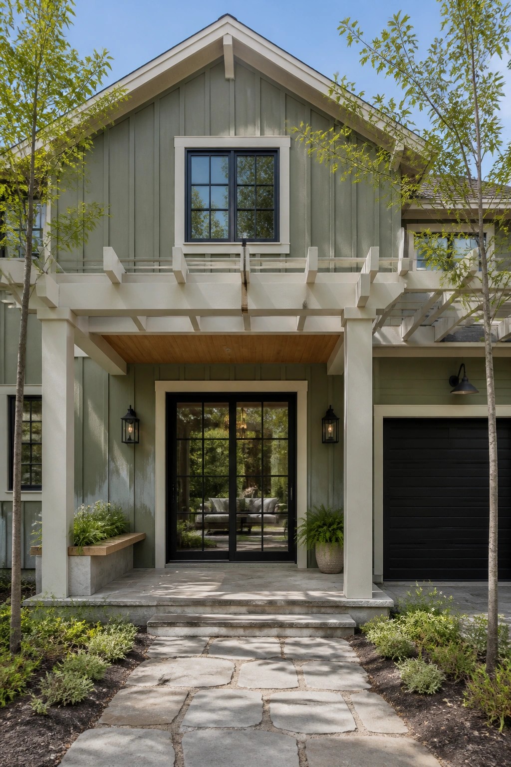 Modern farmhouse exterior with muted sage green siding and white trim.