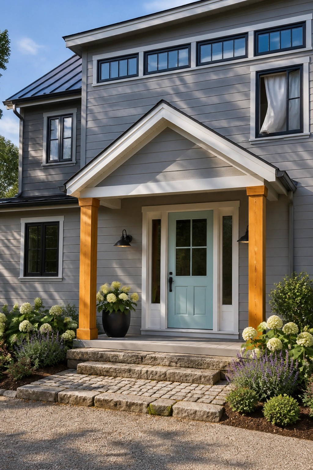 Modern farmhouse exterior with light gray siding and a front porch.