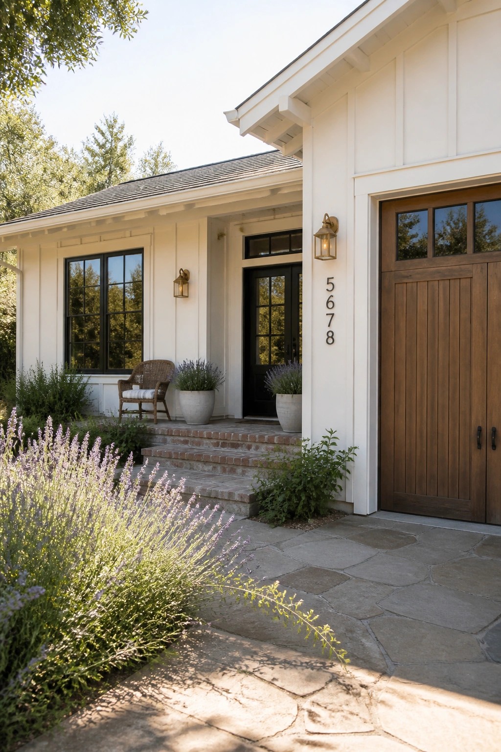 Bright white siding on a modern farmhouse ranch exterior with wood garage doors.