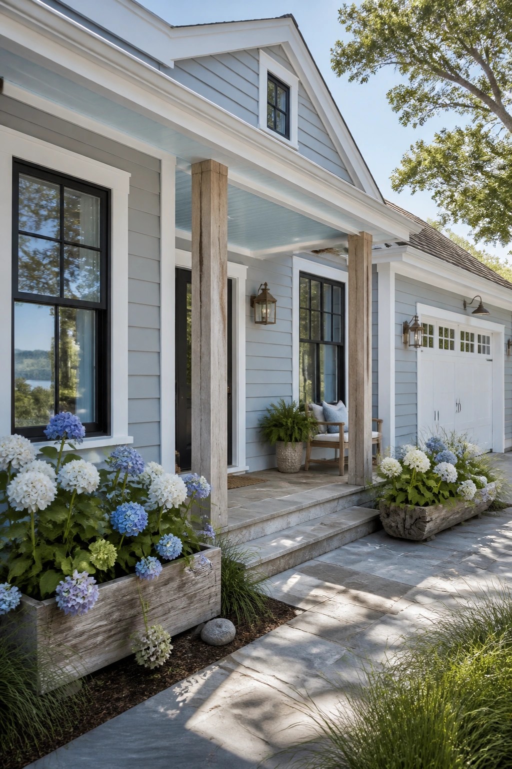 A ranch home with soft blue gray siding and white trim.