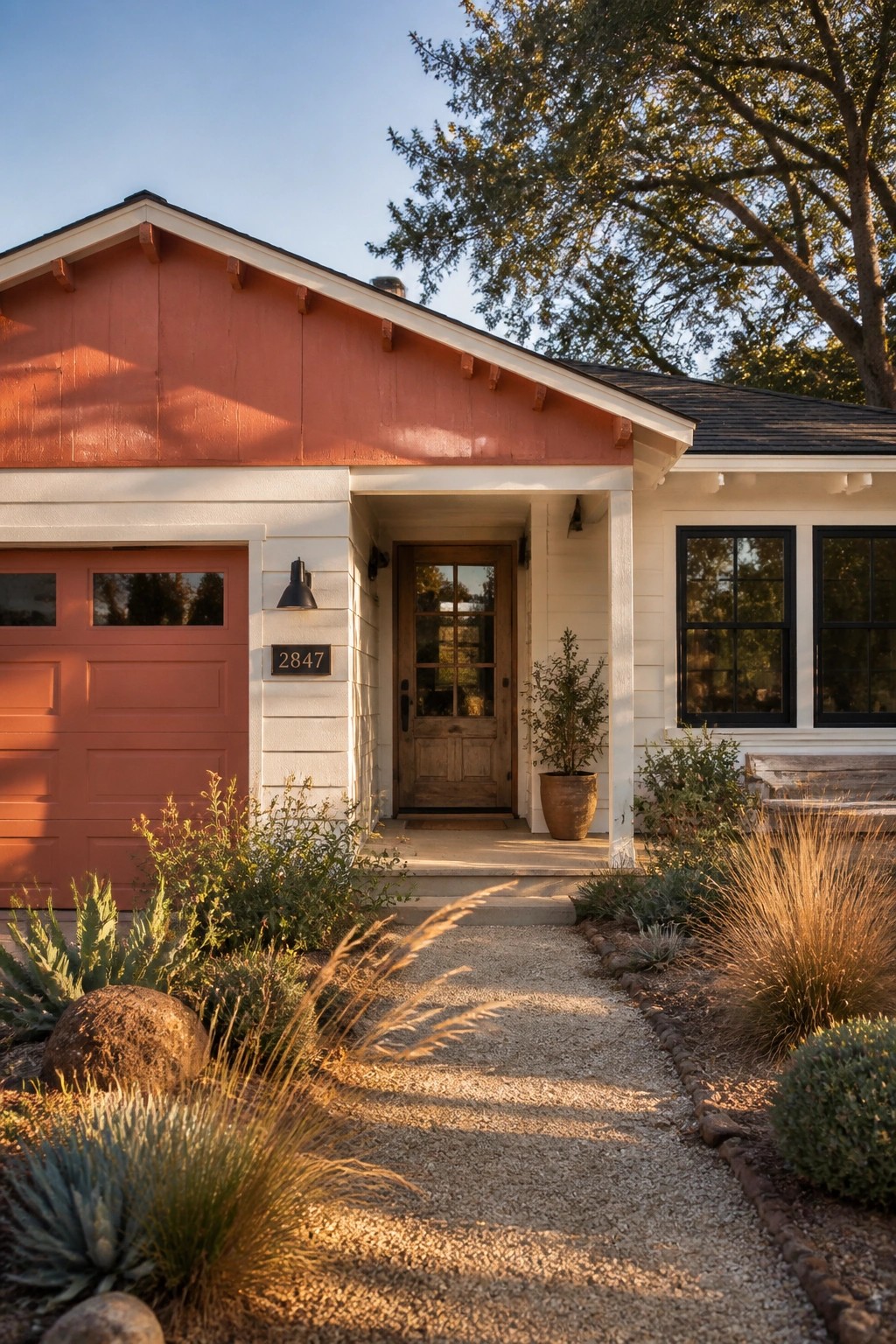 A ranch home exterior painted in warm terracotta with white trim and a matching garage door.