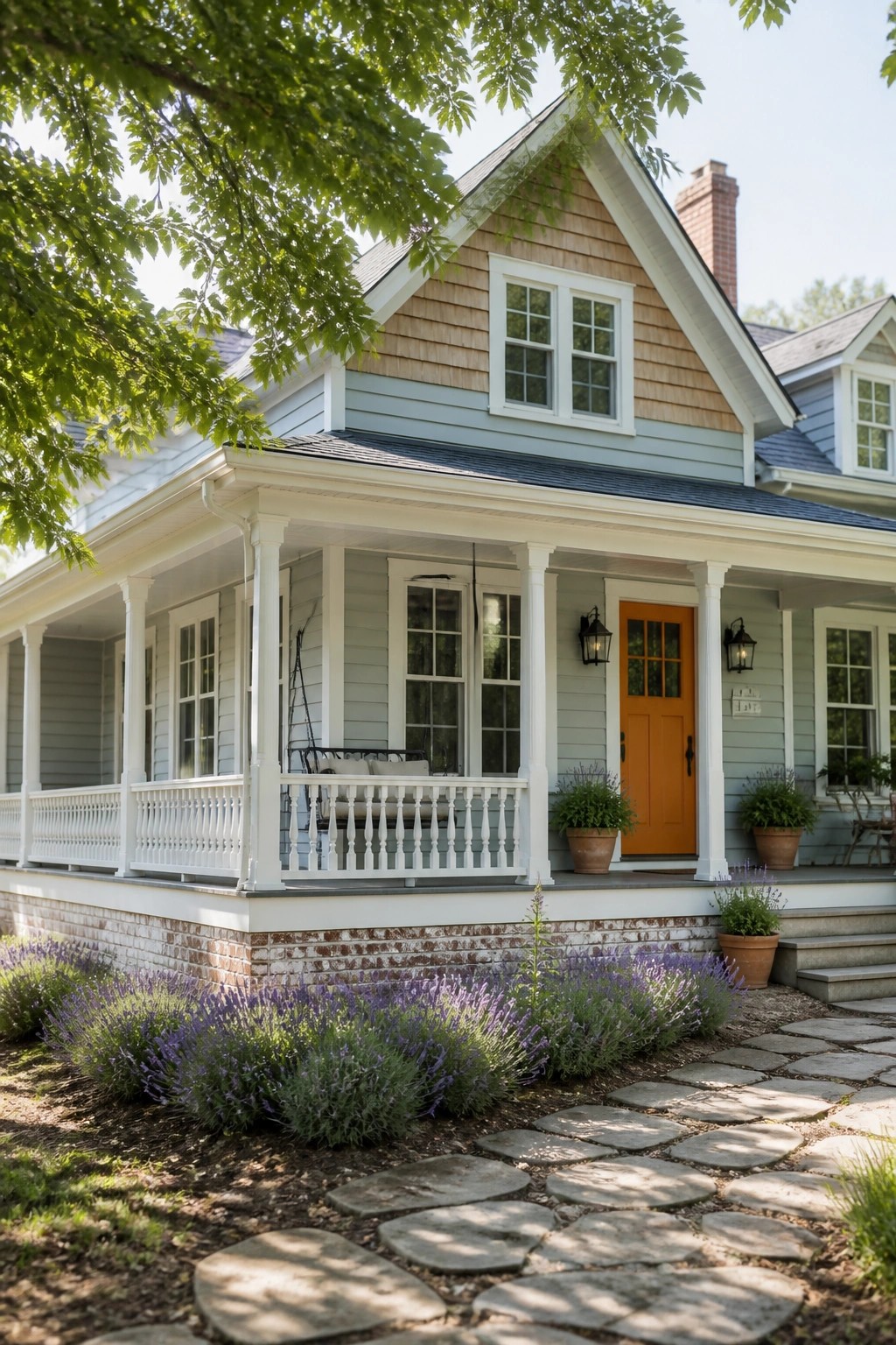 A farmhouse exterior with light blue gray siding and white trim.