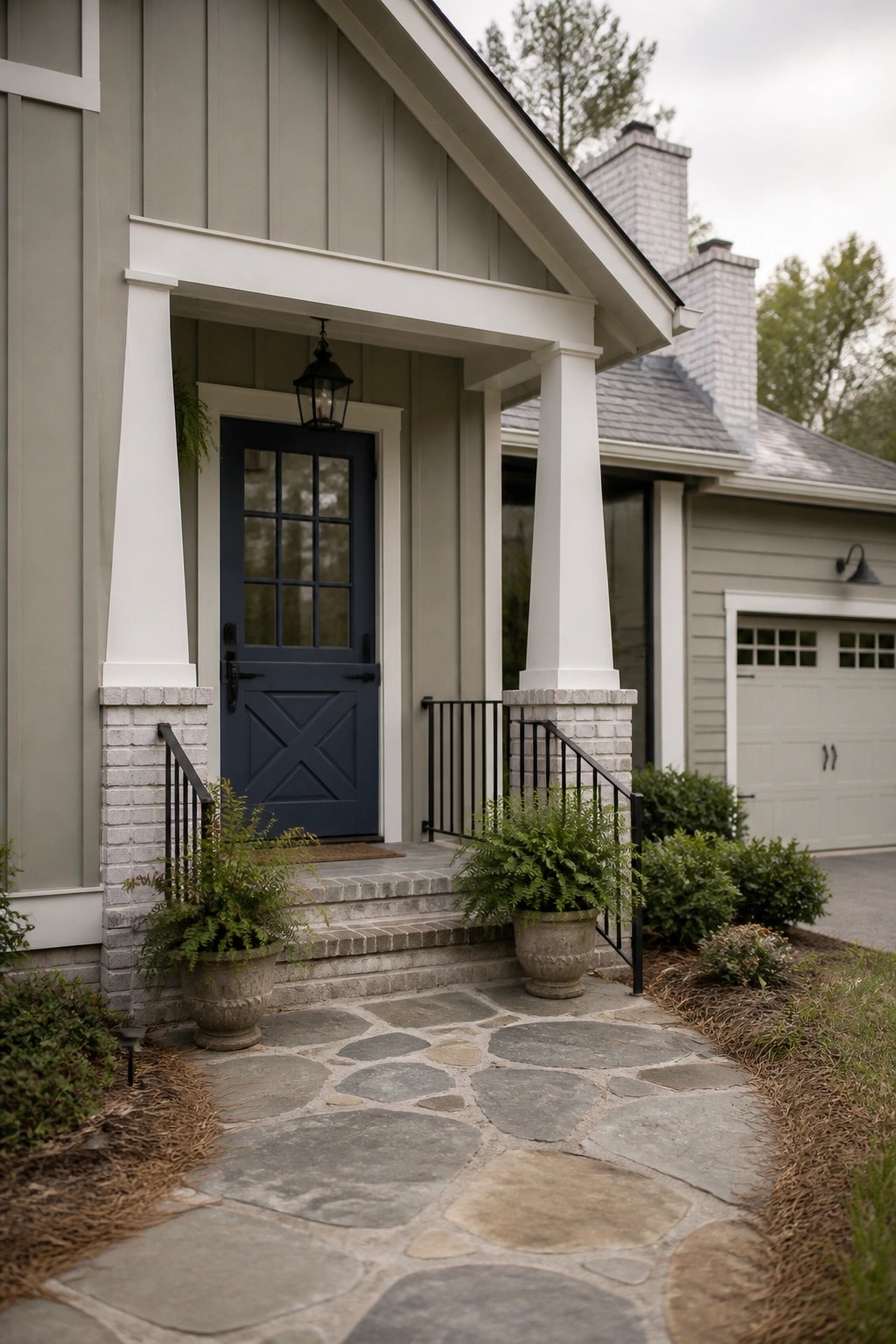Farmhouse exterior with soft sage gray siding and white trim.