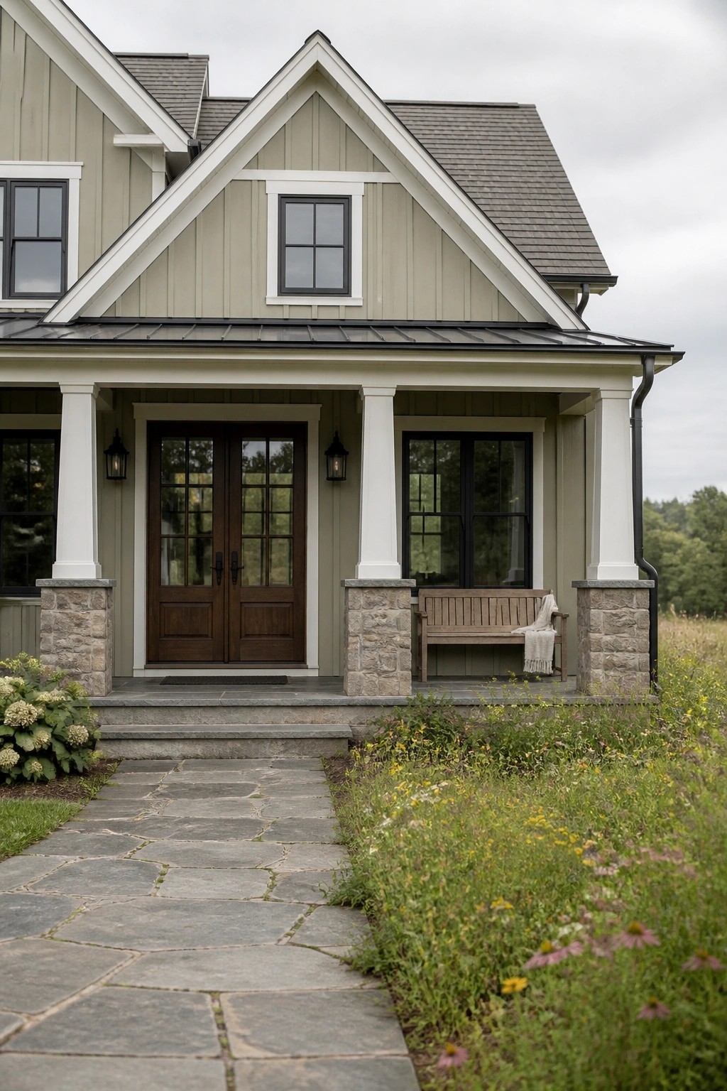 Light greige siding on a modern farmhouse with white trim and stone porch columns.