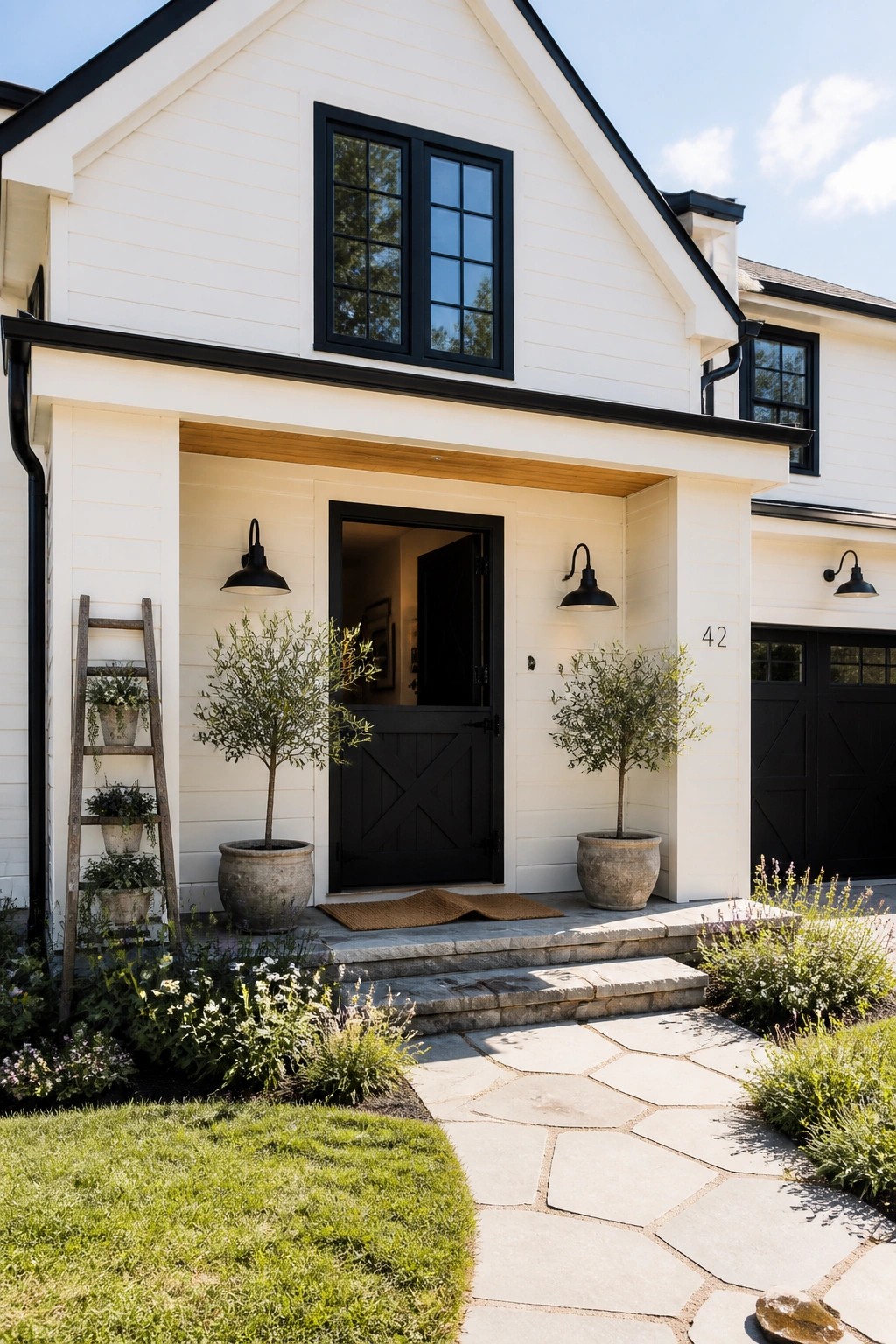 White modern farmhouse exterior with black trim and windows.