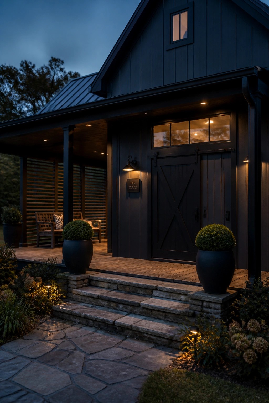 Modern farmhouse exterior painted in deep black siding with a wooden porch.