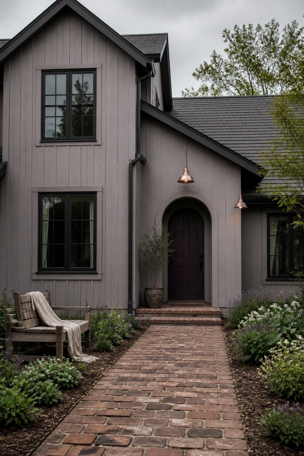 A house exterior with soft gray siding and dark trim.