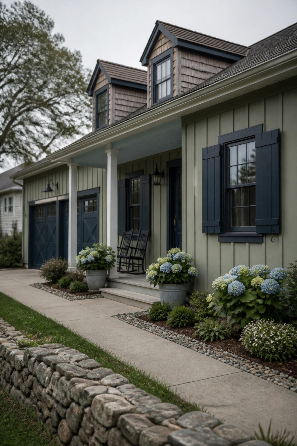 A farmhouse exterior with soft sage green siding and dark trim.