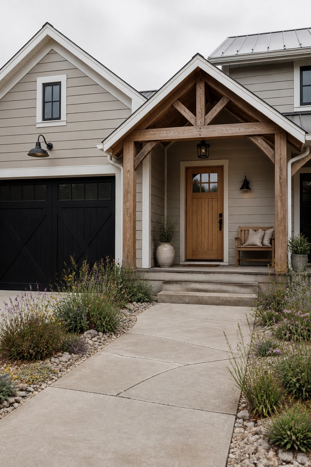 Modern farmhouse entrance with wooden porch, beige siding, and concrete walkway.