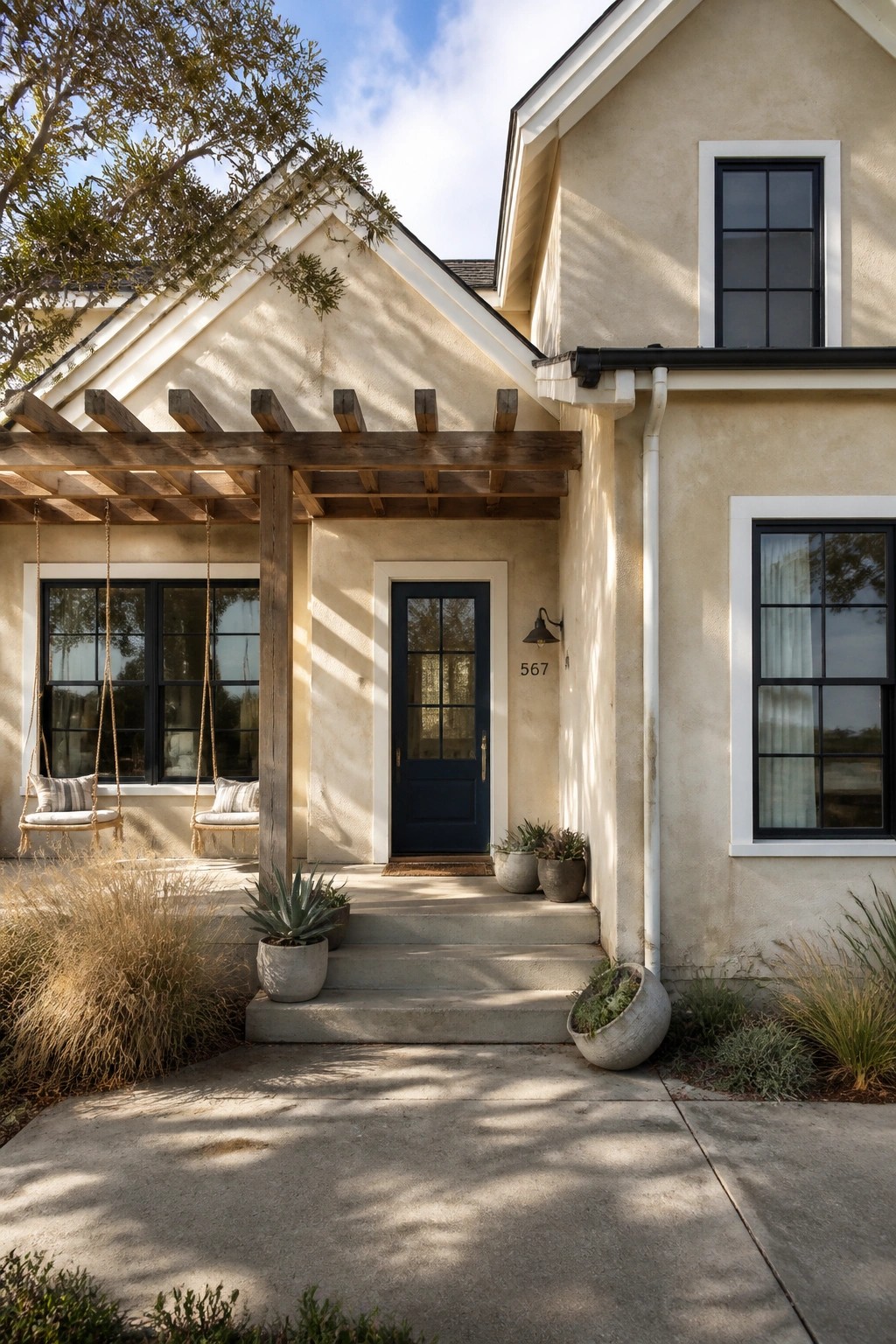 A modern farmhouse exterior with light warm beige siding.