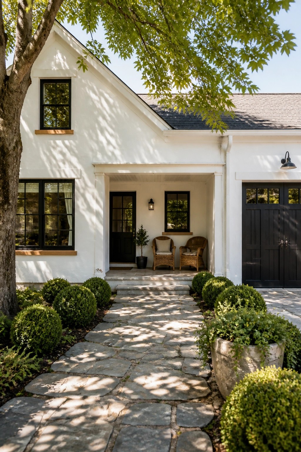 White modern farmhouse exterior with black windows and trim.
