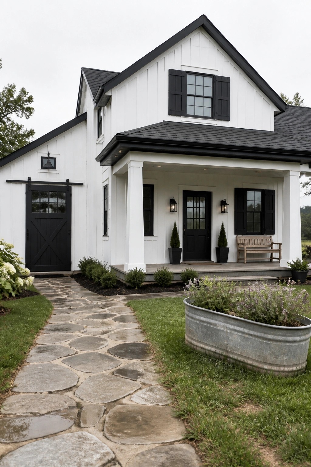 A white farmhouse exterior with black trim and a stone walkway.