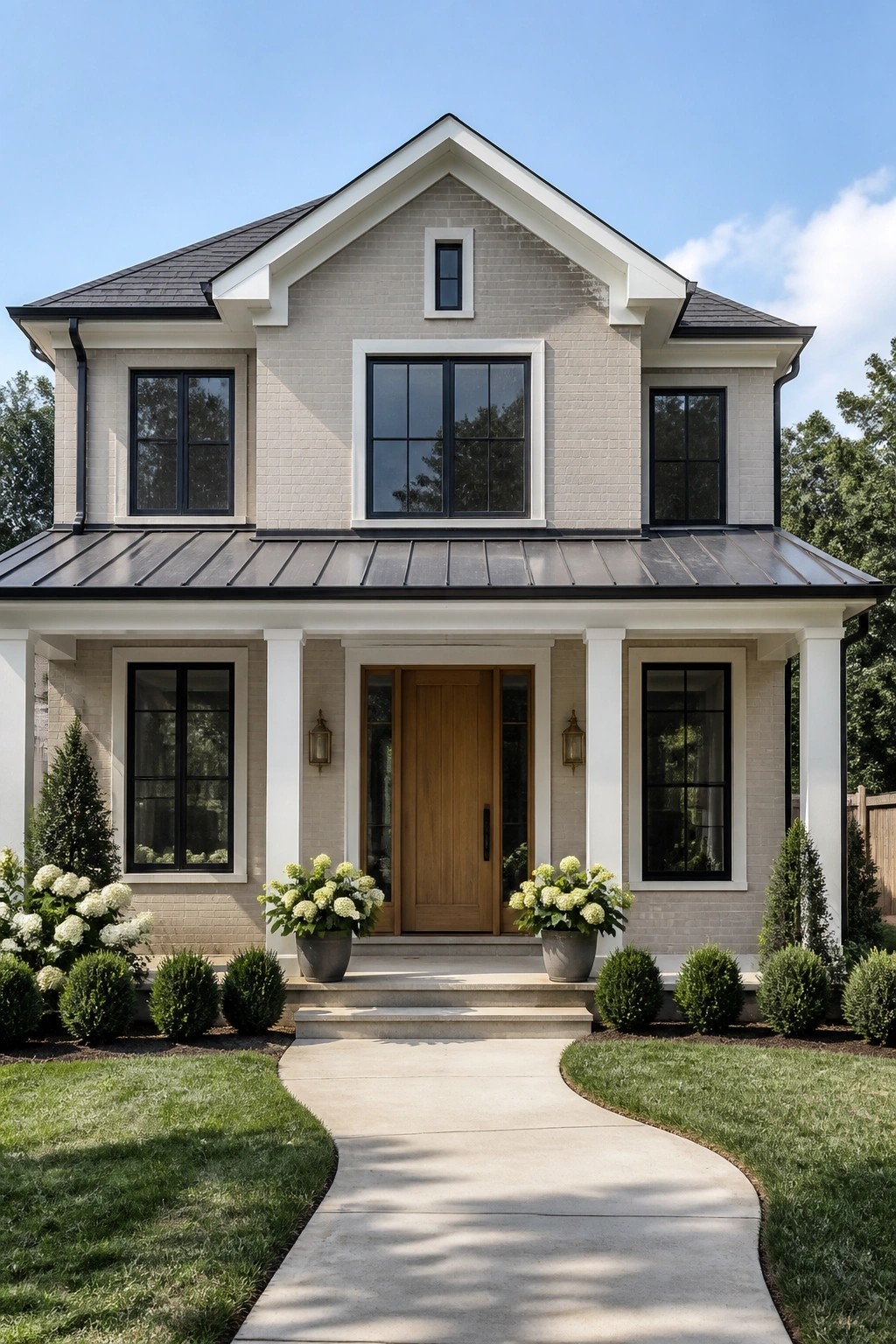 A two-story farmhouse with light greige painted brick and a front porch.