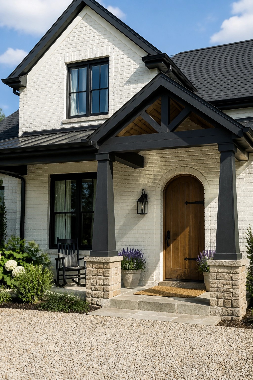 A modern farmhouse exterior with white painted brick siding and black trim.