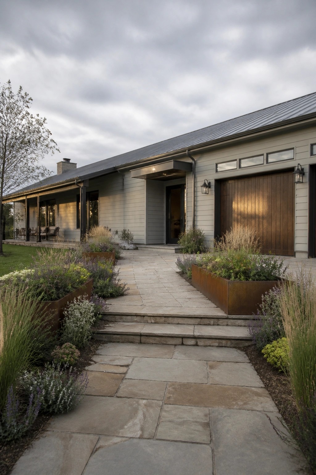 Modern gray house with stone walkway, wooden garage door, and metal planters