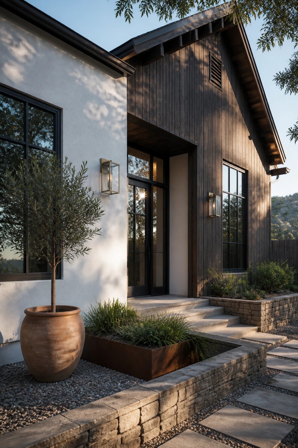 Modern home with white stucco, dark wood siding, black windows, stone steps, and large planter.