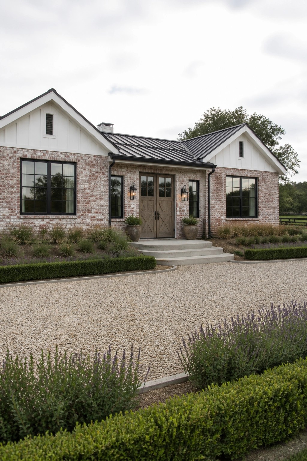 Brick farmhouse with white trim, black roof, and gravel driveway