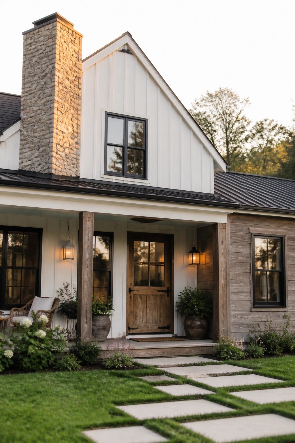 White modern farmhouse with stone chimney, wooden door, and stone pathway.