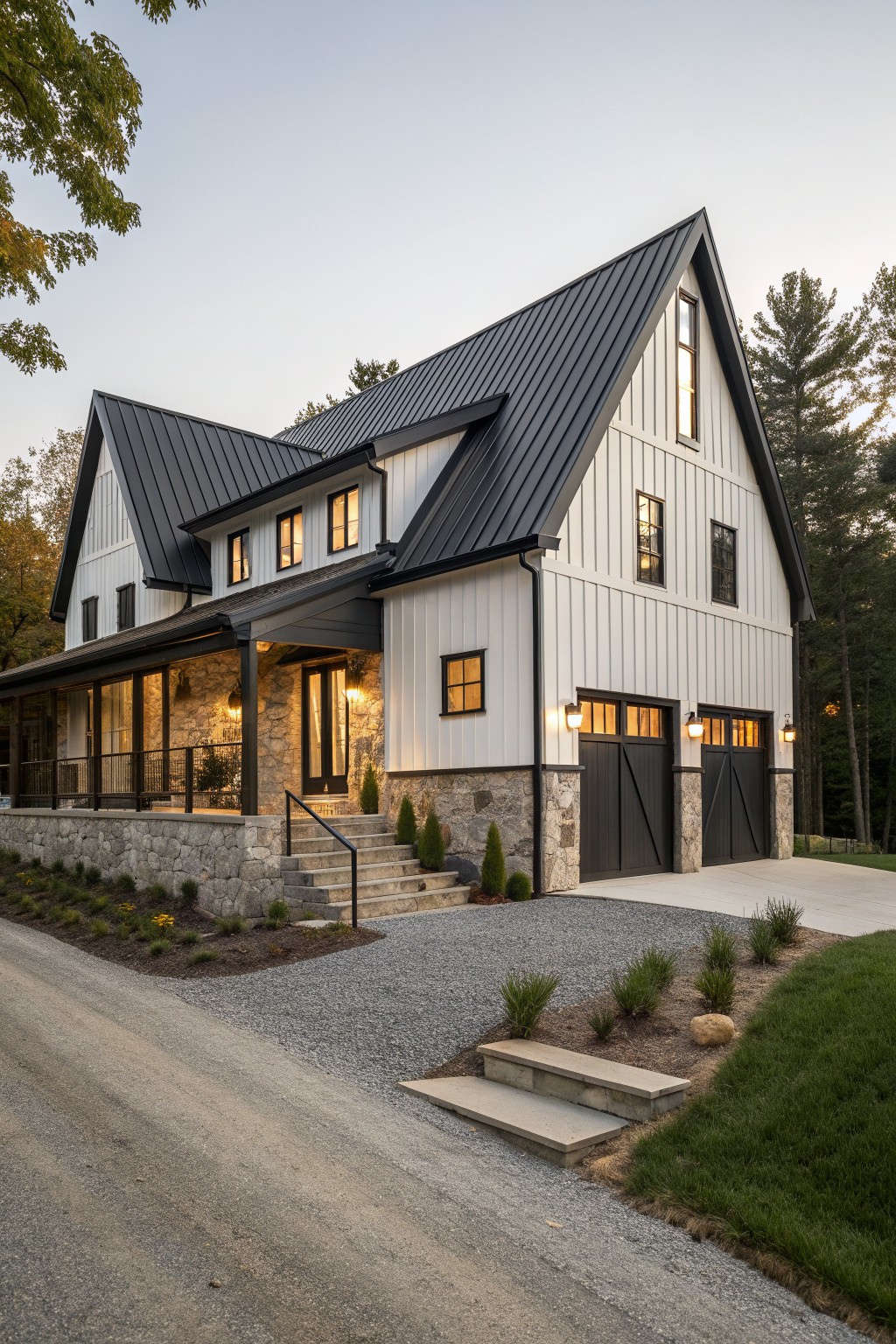 Modern white farmhouse with black metal roof, stone base, and lit garages.