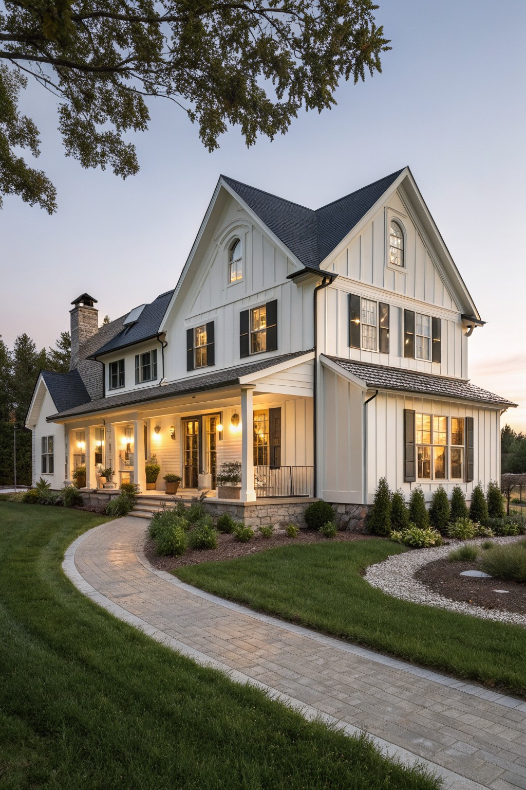 A two-story white farmhouse exterior with a front porch supported by white columns, black shutters, and a curved brick walkway.